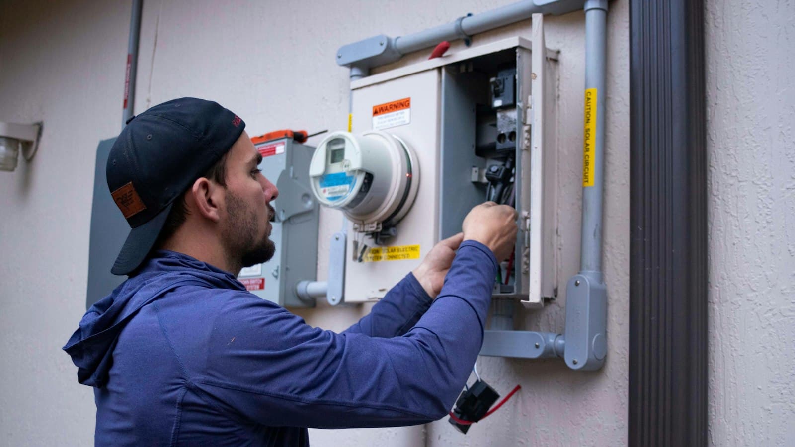 Field technician servicing an electrical meter on site