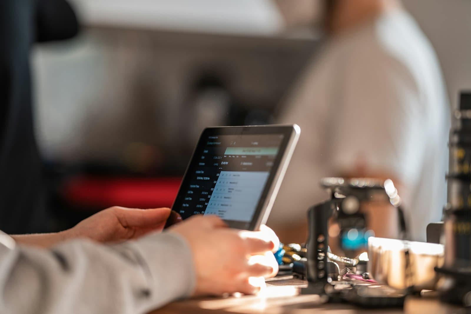 Technician checking a job on a tablet at the repair bench